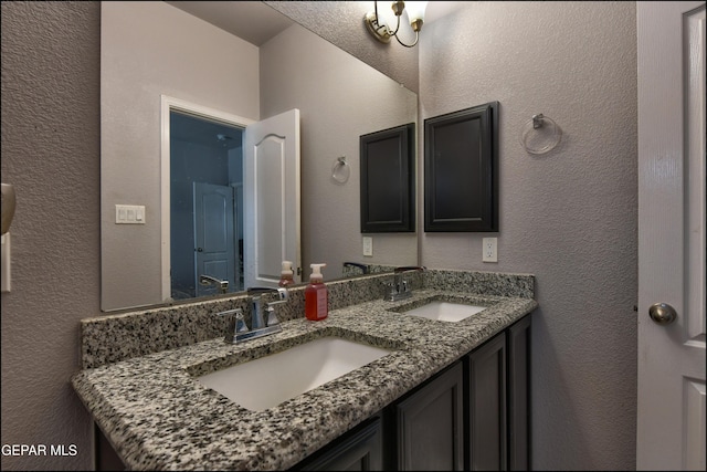 5949 Hidden Palms Dr, El Paso, TX 79924 - bathroom featuring double vanity and a textured wall