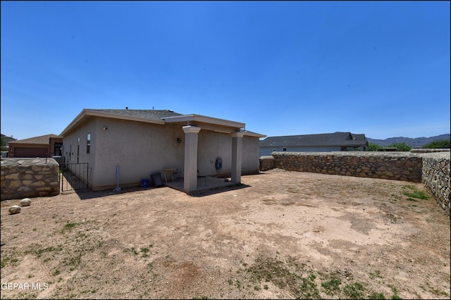 5949 Hidden Palms Dr, El Paso, TX 79924 - back of house with stucco siding, a fenced backyard, a gate, and a patio area