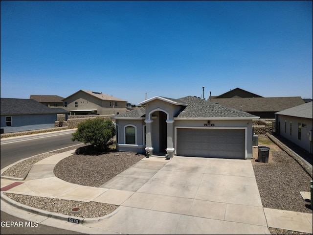 5949 Hidden Palms Dr, El Paso, TX 79924 - view of front facade featuring a garage, concrete driveway, stucco siding, and a shingled roof