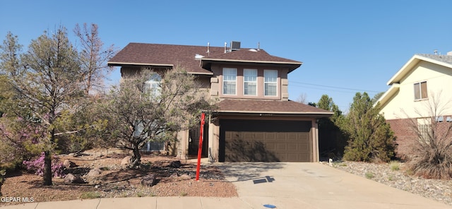 7342 Luz De Villa Ct, El Paso, TX 79912 - traditional home with a garage, concrete driveway, a shingled roof, and stucco siding