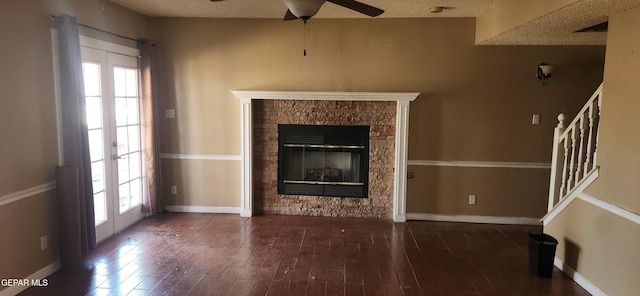 7342 Luz De Villa Ct, El Paso, TX 79912 - unfurnished living room featuring plenty of natural light, ceiling fan, a stone fireplace, and wood finished floors