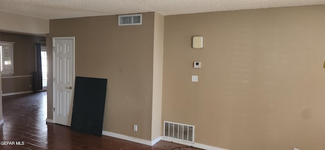 7342 Luz De Villa Ct, El Paso, TX 79912 - empty room with dark wood-style flooring and a textured ceiling