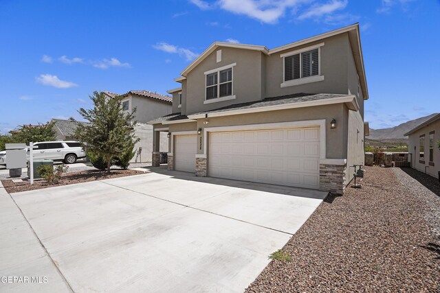 2228 Thawline Pl, El Paso, TX 79911 - view of front of home with stucco siding, an attached garage, stone siding, and concrete driveway