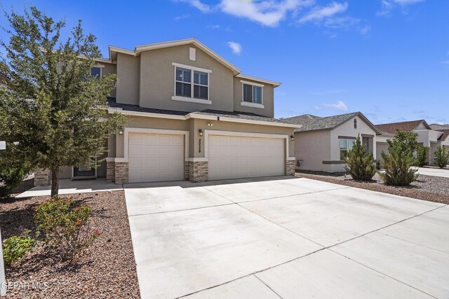 2228 Thawline Pl, El Paso, TX 79911 - view of front of property with stucco siding, stone siding, a garage, and driveway