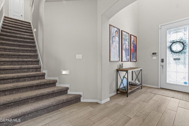 2228 Thawline Pl, El Paso, TX 79911 - entryway with wood tiled floors, stairway, and arched walkways