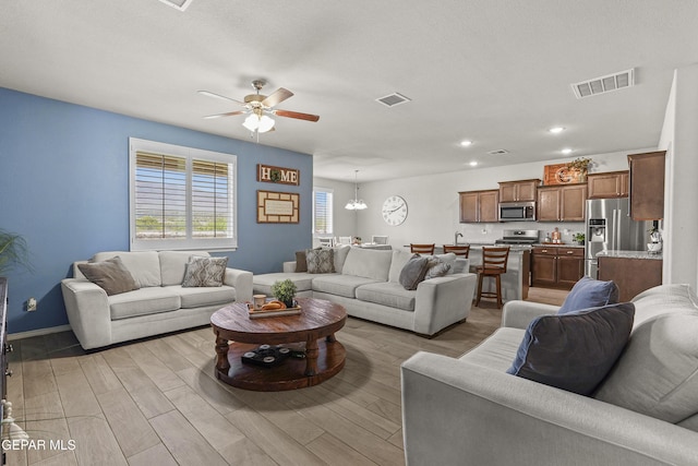 2228 Thawline Pl, El Paso, TX 79911 - living room with a ceiling fan, light wood-style flooring, and recessed lighting