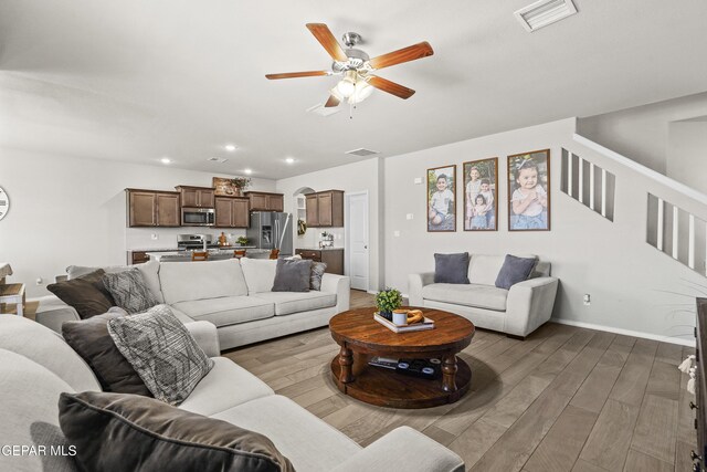 2228 Thawline Pl, El Paso, TX 79911 - living area with a ceiling fan, wood finished floors, recessed lighting, arched walkways, and stairs