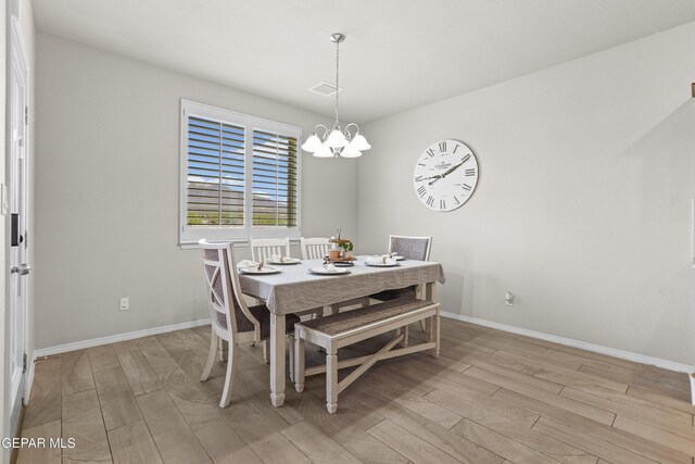 2228 Thawline Pl, El Paso, TX 79911 - dining room with a chandelier and light wood-type flooring