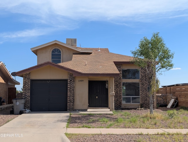11828 Tracy Austin Ln, El Paso, TX 79936 - view of front of property with brick siding, concrete driveway, roof with shingles, and an attached garage