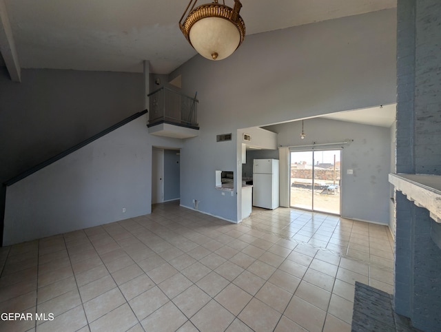 11828 Tracy Austin Ln, El Paso, TX 79936 - unfurnished living room featuring light tile patterned floors and high vaulted ceiling