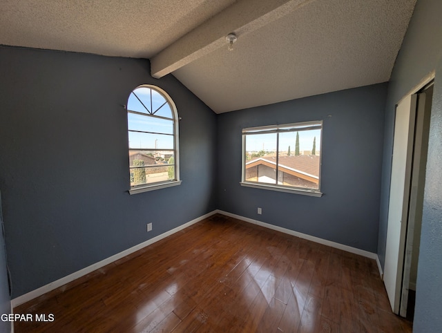 11828 Tracy Austin Ln, El Paso, TX 79936 - spare room with plenty of natural light, wood-type flooring, a textured ceiling, and fire sprinkler in ceiling