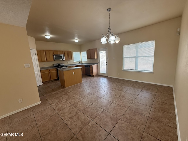11025 Acoma St, El Paso, TX 79934 - kitchen featuring appliances with stainless steel finishes, tile patterned flooring, a center island, and a chandelier