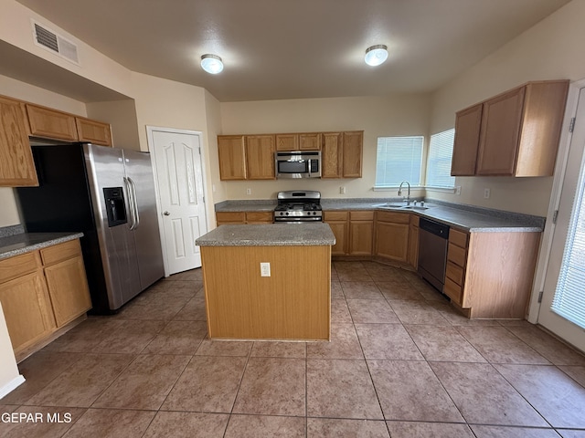 11025 Acoma St, El Paso, TX 79934 - kitchen with stainless steel appliances, a kitchen island, plenty of natural light, and light tile patterned floors