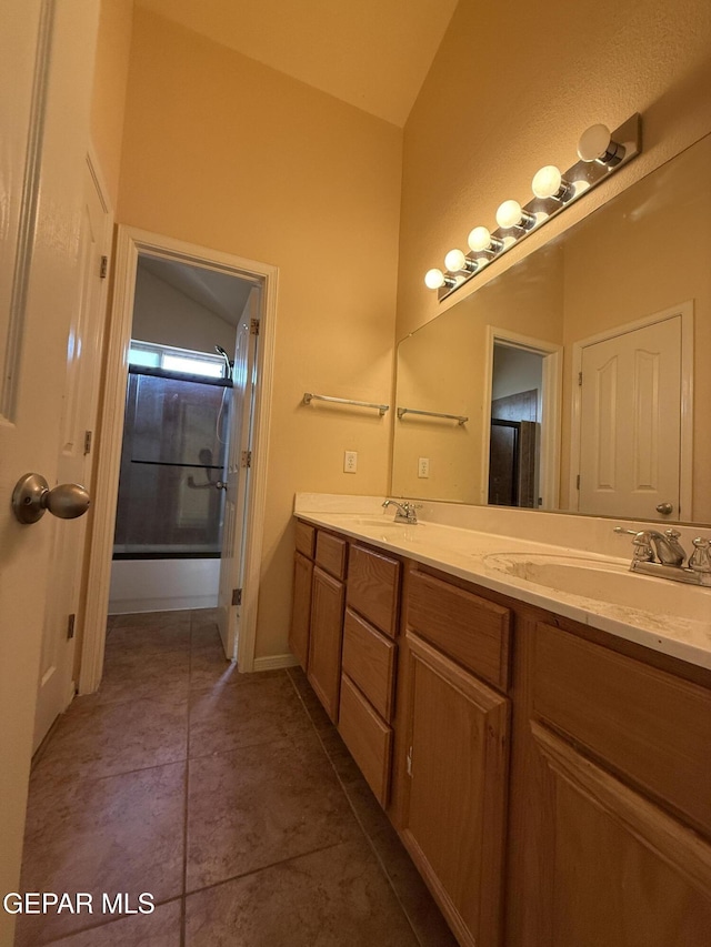 11025 Acoma St, El Paso, TX 79934 - bathroom with double vanity, lofted ceiling, and tile patterned flooring