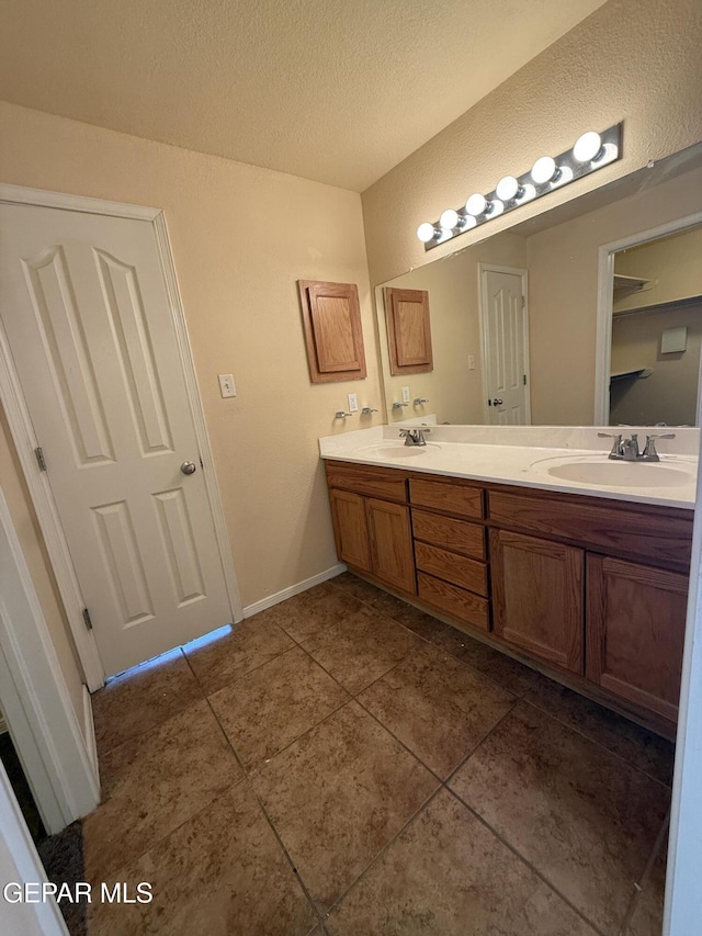 11025 Acoma St, El Paso, TX 79934 - full bath featuring double vanity, tile patterned floors, and a textured ceiling