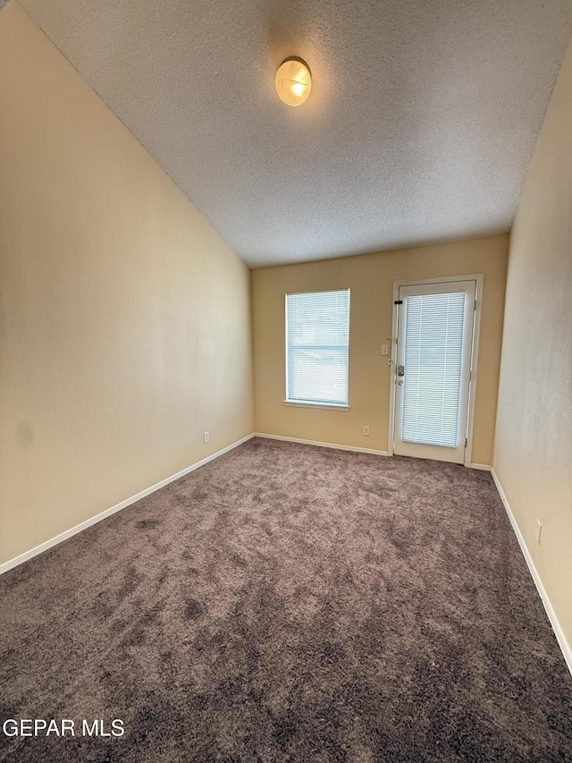 11025 Acoma St, El Paso, TX 79934 - carpeted empty room with a textured ceiling