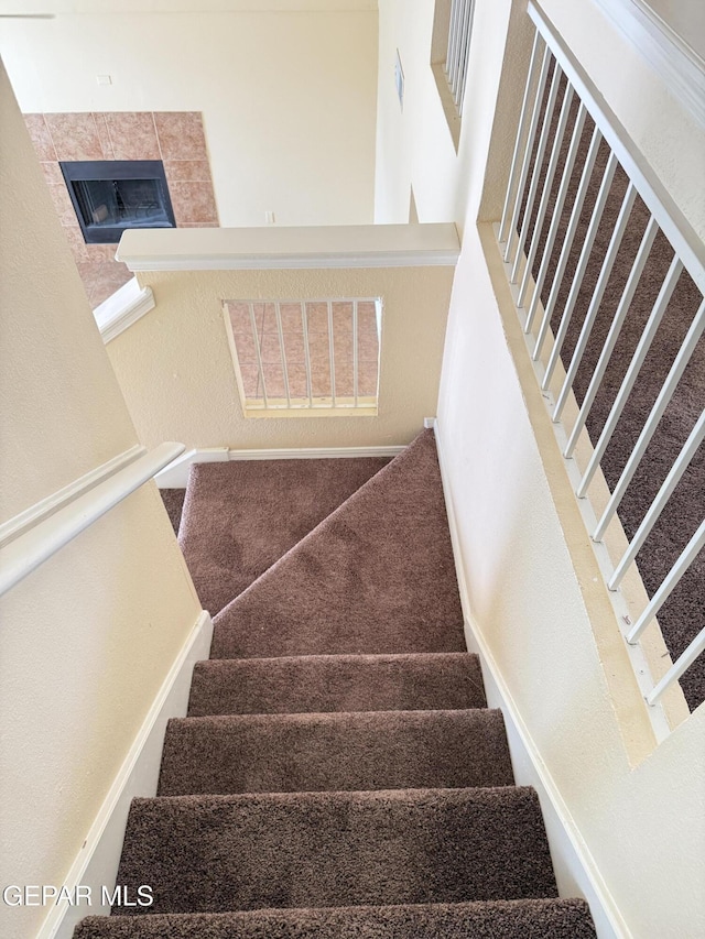 11025 Acoma St, El Paso, TX 79934 - staircase featuring a tile fireplace