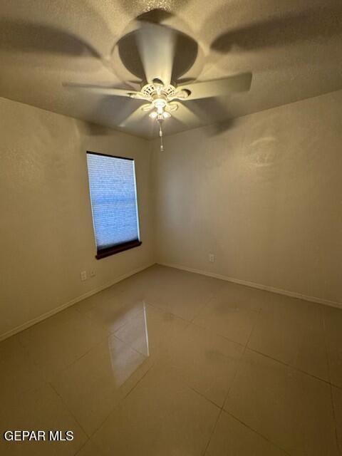 1718 Challenger Ln, El Paso, TX 79936 - tiled empty room featuring ceiling fan and baseboards