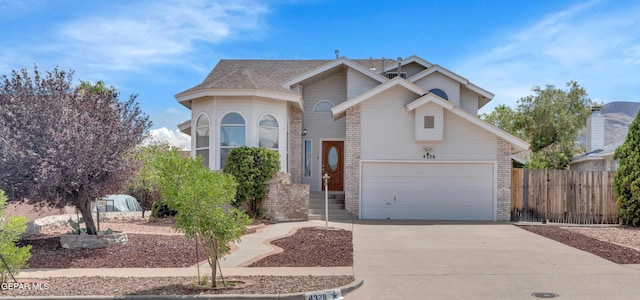 4328 Loma Alegre Dr, El Paso, TX 79934 - view of front of house with driveway, brick siding, and an attached garage