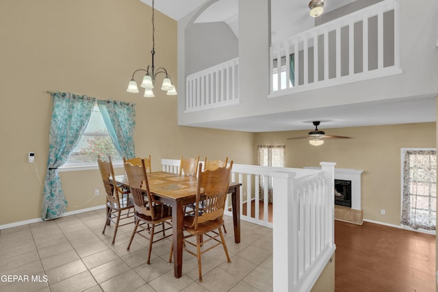 4328 Loma Alegre Dr, El Paso, TX 79934 - dining space featuring high vaulted ceiling, a chandelier, ceiling fan, a fireplace with raised hearth, and tile patterned floors