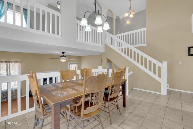 4328 Loma Alegre Dr, El Paso, TX 79934 - tiled dining room featuring a towering ceiling, healthy amount of natural light, a chandelier, and stairs