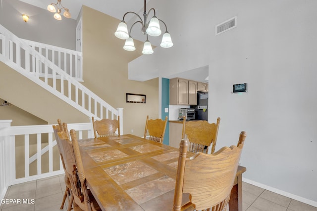 4328 Loma Alegre Dr, El Paso, TX 79934 - dining area with light tile patterned floors, stairway, a chandelier, and a towering ceiling