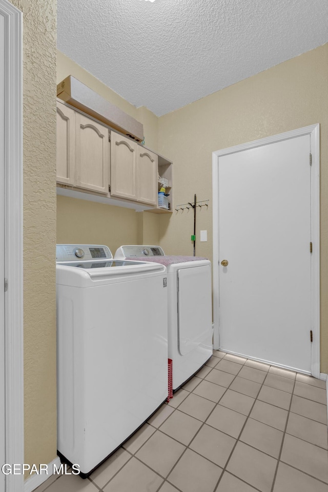 4328 Loma Alegre Dr, El Paso, TX 79934 - washroom with cabinet space, independent washer and dryer, a textured ceiling, and light tile patterned floors