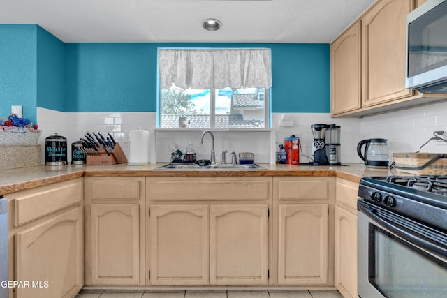 4328 Loma Alegre Dr, El Paso, TX 79934 - kitchen with stainless steel microwave, gas stove, decorative backsplash, and light countertops