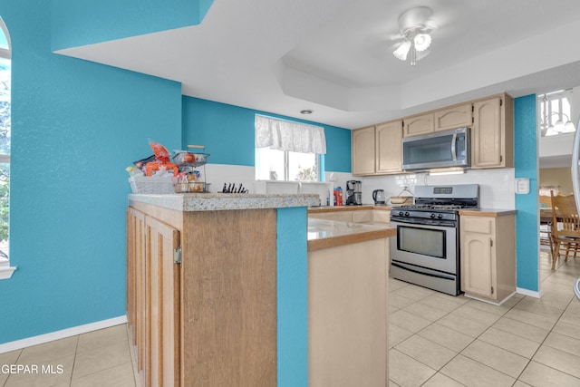 4328 Loma Alegre Dr, El Paso, TX 79934 - kitchen with appliances with stainless steel finishes, light tile patterned floors, a tray ceiling, backsplash, and ceiling fan