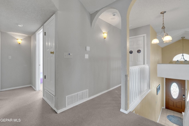 4328 Loma Alegre Dr, El Paso, TX 79934 - entrance foyer with arched walkways, light colored carpet, a textured ceiling, and vaulted ceiling