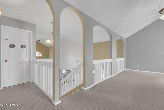 4328 Loma Alegre Dr, El Paso, TX 79934 - hallway with carpet, lofted ceiling, and arched walkways