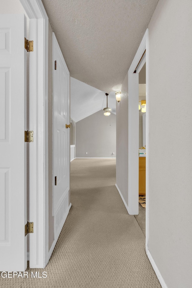 4328 Loma Alegre Dr, El Paso, TX 79934 - corridor featuring light carpet, a textured ceiling, and lofted ceiling