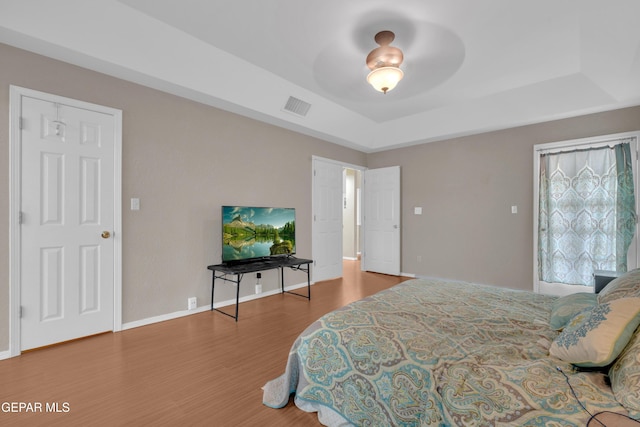 4328 Loma Alegre Dr, El Paso, TX 79934 - bedroom featuring a raised ceiling and wood finished floors