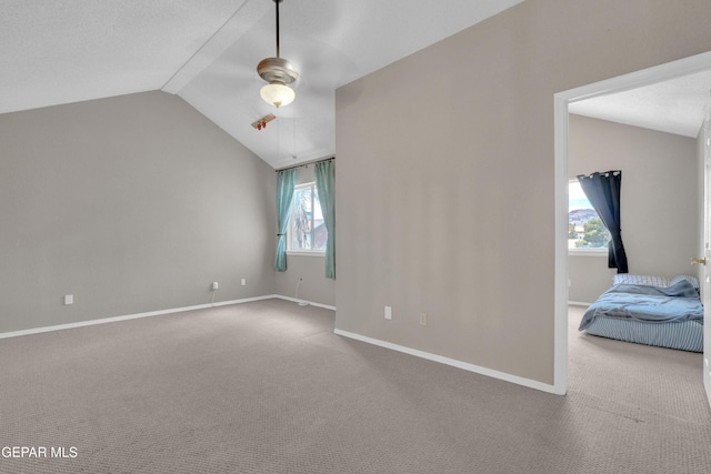 4328 Loma Alegre Dr, El Paso, TX 79934 - empty room with vaulted ceiling, carpet floors, healthy amount of natural light, and ceiling fan