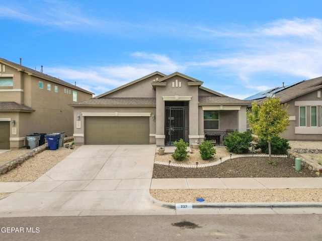 237 Gonzalo Cir, El Paso, TX 79932 - view of front facade featuring stucco siding, an attached garage, and driveway