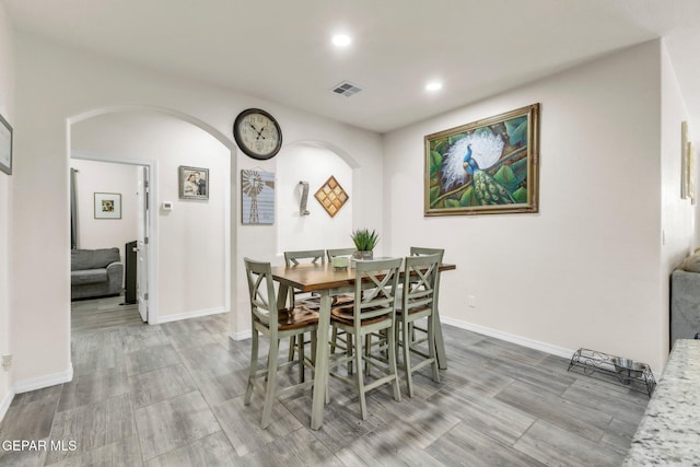 237 Gonzalo Cir, El Paso, TX 79932 - dining space featuring arched walkways, recessed lighting, and wood finished floors