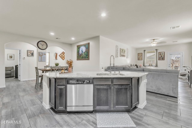 237 Gonzalo Cir, El Paso, TX 79932 - kitchen featuring dishwasher, open floor plan, arched walkways, a kitchen island with sink, and recessed lighting