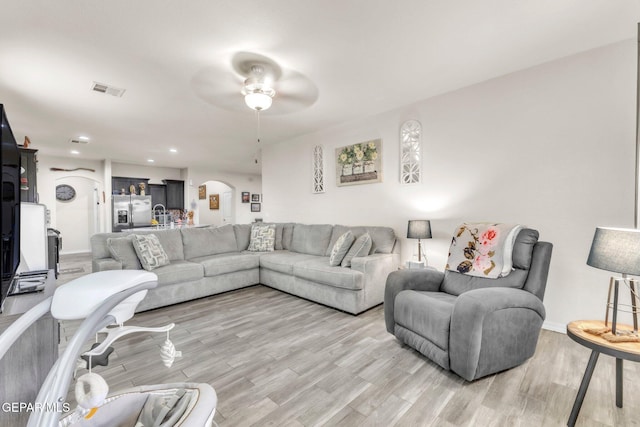 237 Gonzalo Cir, El Paso, TX 79932 - living area featuring light wood-type flooring, a ceiling fan, arched walkways, and recessed lighting
