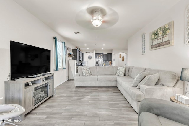237 Gonzalo Cir, El Paso, TX 79932 - living room with a ceiling fan, recessed lighting, light wood-style flooring, and arched walkways