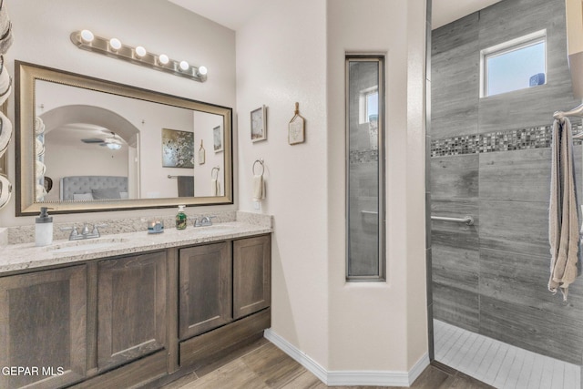 237 Gonzalo Cir, El Paso, TX 79932 - bathroom featuring double vanity, walk in shower, a ceiling fan, and wood finished floors