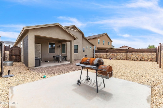 237 Gonzalo Cir, El Paso, TX 79932 - rear view of house featuring a patio area, a fenced backyard, stucco siding, and a gate