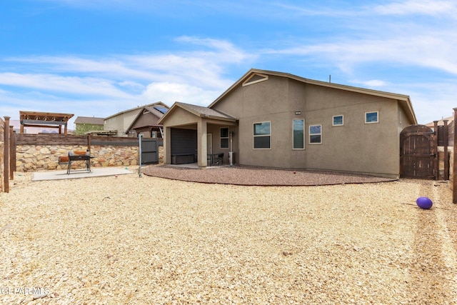 237 Gonzalo Cir, El Paso, TX 79932 - rear view of property featuring a gate, a patio area, and stucco siding