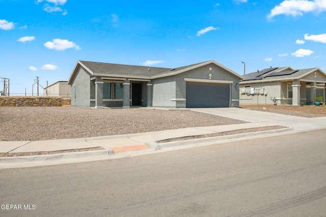 14207 Desierto Bonito St, Horizon City, TX 79928 - ranch-style home featuring stucco siding, an attached garage, and driveway