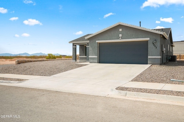 14207 Desierto Bonito St, Horizon City, TX 79928 - ranch-style home featuring stucco siding, a garage, driveway, and a mountain view