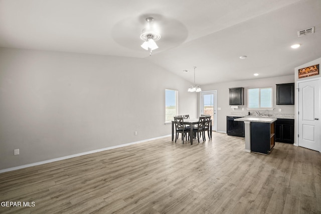 14207 Desierto Bonito St, Horizon City, TX 79928 - kitchen with a ceiling fan, light countertops, a center island, a chandelier, and vaulted ceiling