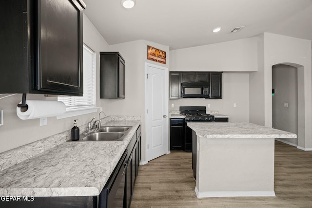 14207 Desierto Bonito St, Horizon City, TX 79928 - kitchen featuring black appliances, light wood-style flooring, a kitchen island, light countertops, and recessed lighting