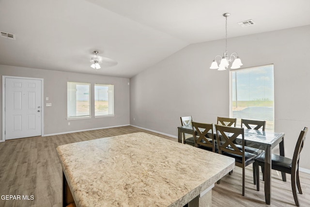 14207 Desierto Bonito St, Horizon City, TX 79928 - dining space with light wood-style floors, a chandelier, vaulted ceiling, and a ceiling fan