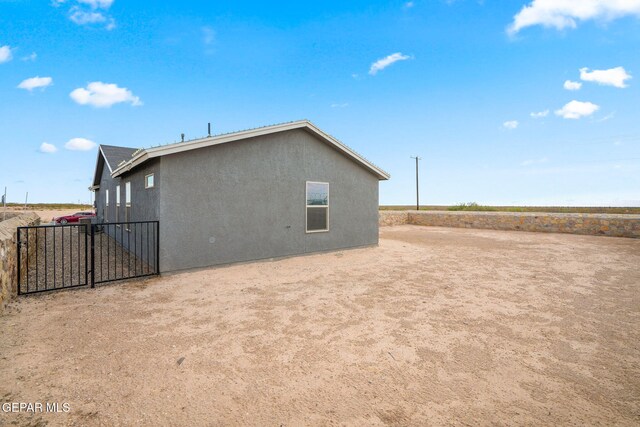 14207 Desierto Bonito St, Horizon City, TX 79928 - view of side of home with stucco siding