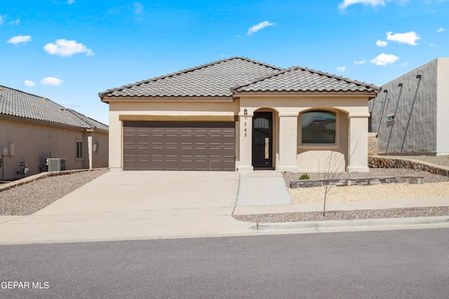 245 Hunstanton St, Horizon City, TX 79928 - mediterranean / spanish-style home featuring an attached garage, stucco siding, concrete driveway, and a tile roof