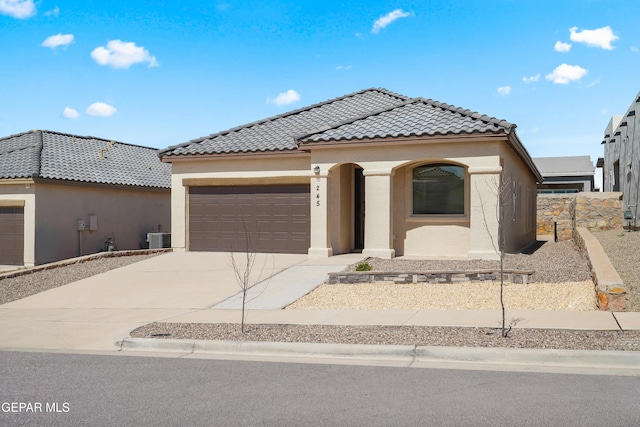245 Hunstanton St, Horizon City, TX 79928 - mediterranean / spanish house featuring driveway, stucco siding, an attached garage, and a tile roof